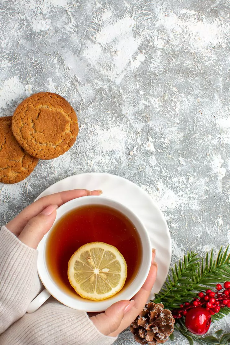 vertical-view-cup-black-tea-with-lemon-fir-branches-with